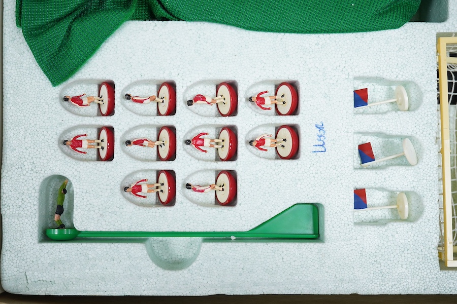 Two boxed Subbuteo table football sets; a European Edition, comprising of two teams, spectators and line side staff, pitch, etc. (some parts missing), and an International Edition, comprising of three teams, stadium ligh